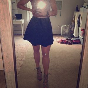 Black form holding dancer skirt